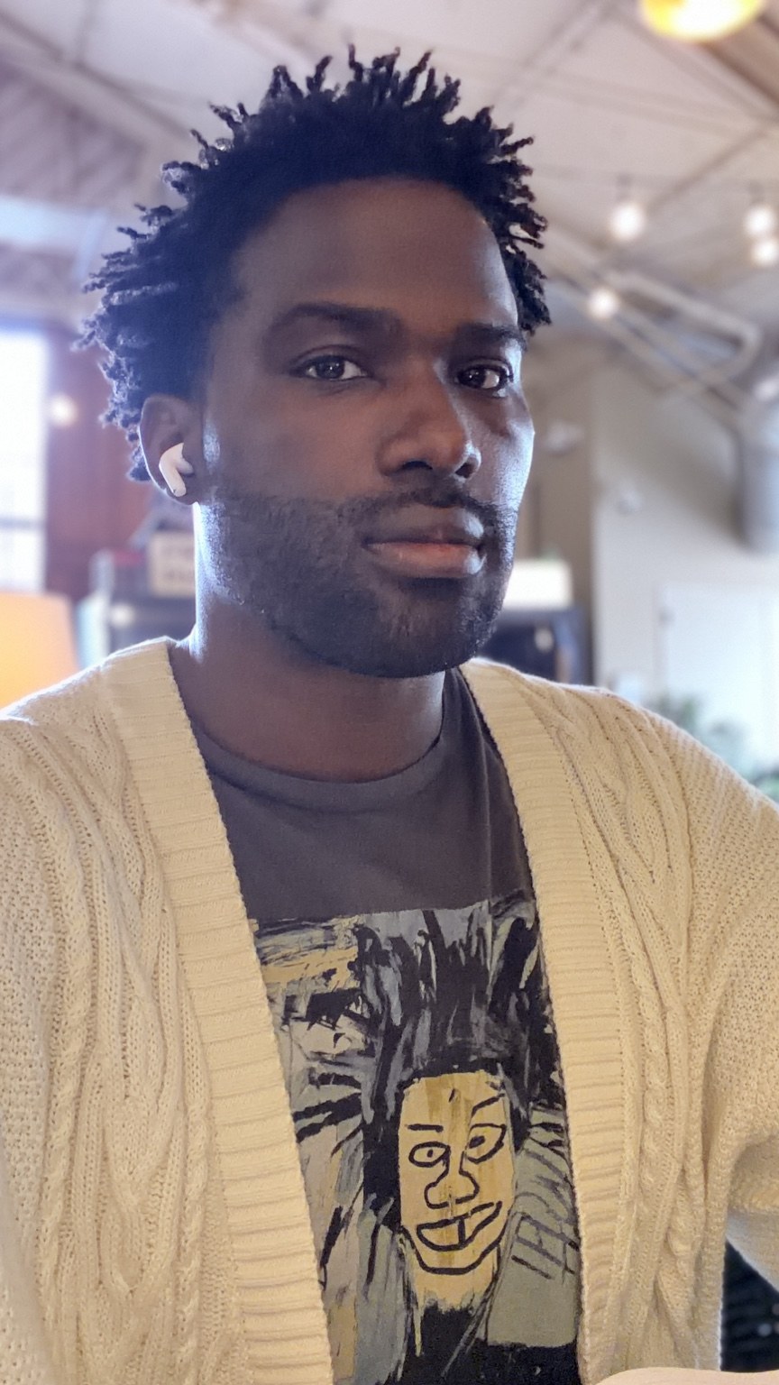 Portrait of Phil BeLight in a cream cardigan